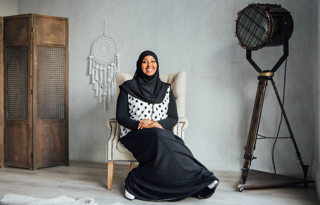 Eman Ahmed, founder of The Good Child Academy, seated and smiling